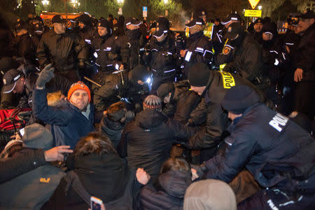 FILE PHOTO: People scuffle with police as they try to block the road to the Polish Parliament in Warsaw December 17, 2016. Agencja Gazeta/Michal Jazwiecki/via Reuters/File Photo