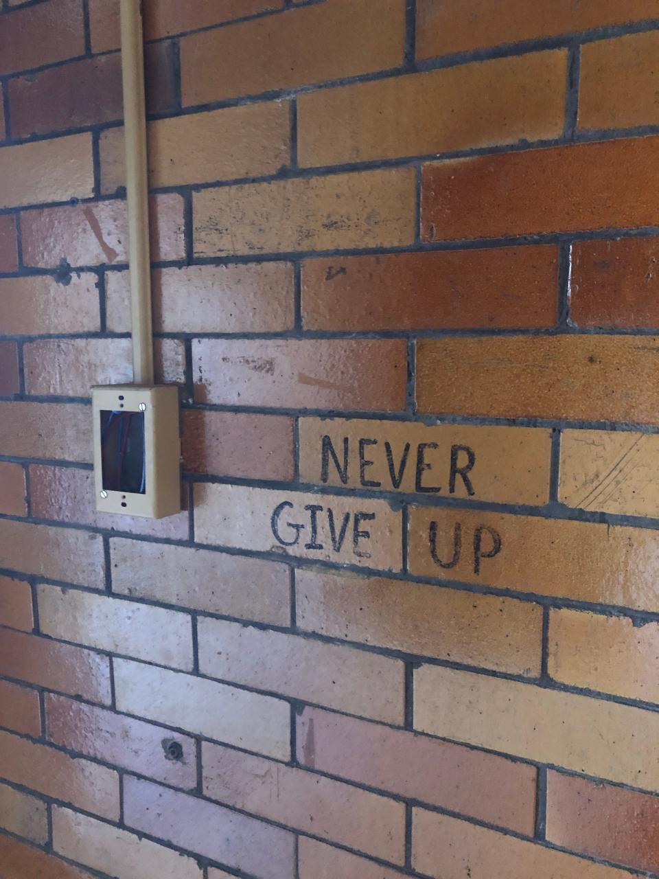 "Never Give Up" is written on a wall inside the former North Lincoln School in Alliance which is expected to be demolished. The school was built in 1914.