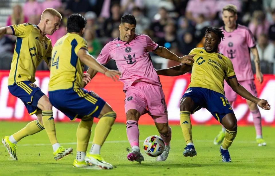 Inter Miami forward Luis Suárez (9) tries to score as Real Salt Lake defender Brayan Vera (4) and forward Emeka Eneli (14) defend in the first half of their MLS match at Chase Stadium on Wednesday, Feb. 21, 2024, in Fort Lauderdale, Fla.