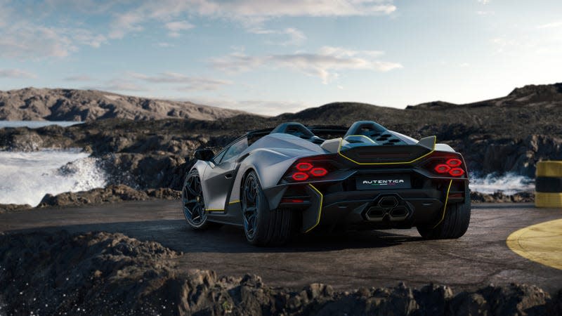 A rear view of the Lamborghini Invencible roadster in front of crashing waves.