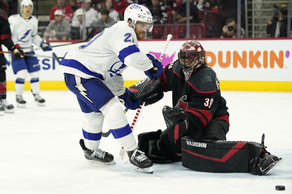 Tampa Bay Lightning center Blake Coleman (20) tries to score against Carolina Hurricanes goaltender Alex Nedeljkovic (39) during the third period in Game 1 of an NHL hockey Stanley Cup second-round playoff series in Raleigh, N.C., Sunday, May 30, 2021. (AP Photo/Gerry Broome)