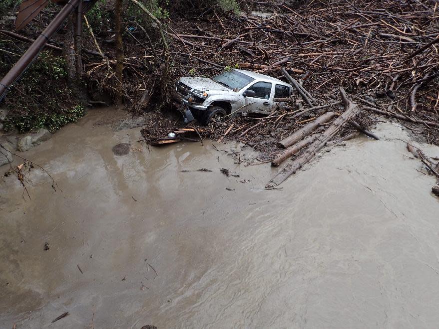 A vehicle is seen after it was swept away by storm runoff at El Capitan Canyon Resort & Campground in Gaviota, Calif., on Friday, Jan. 20, 2017. A flood on the southern Santa Barbara County coast has swept cabins and vehicles down a narrow canyon as the latest storm drenches California. County Fire Department Capt. Dave Zaniboni says a creek overflowed at midmorning Friday and swept five cabins and 15 vehicles down the canyon which lies just above El Capitan State Beach. (Mike Eliason/Santa Barbara County Fire Dept. via AP)