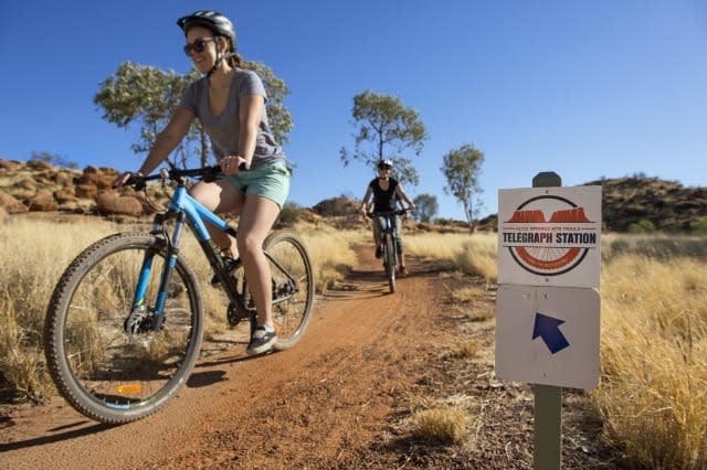 Mountain biking on the trail around Alice Springs Telegraph Station