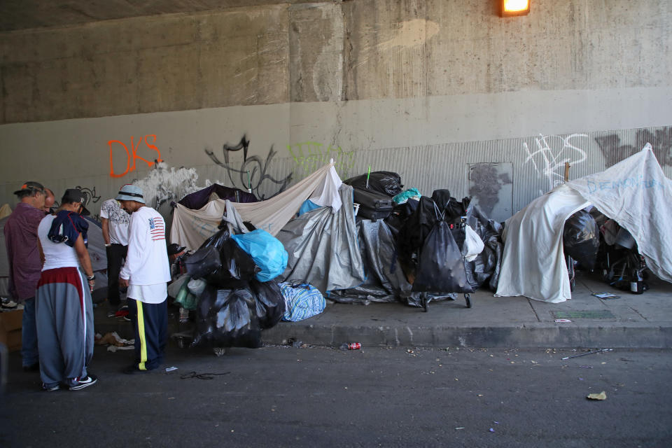 The “harsh conditions of homelessness,” notes one expert, puts such populations “at increased risk for severe illness, even death.” Pictured here is a homeless encampment under the 101 Freeway in Los Angeles before it was cleared in response to the pandemic. (Photo: David Livingston/Getty Images)