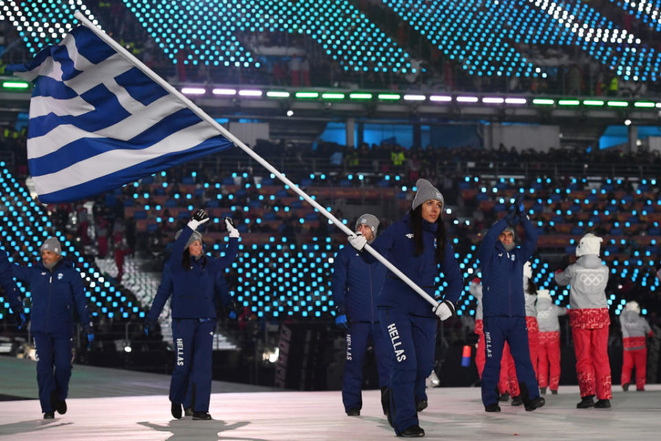 <p>Flag bearer Sophia Ralli of Greece leads the team, who all wear a monochromatic navy winter outfit with “Hellas” printed on the trousers during the opening ceremony of the 2018 PyeongChang Games. (Photo: Quinn Rooney/Getty Images) </p>