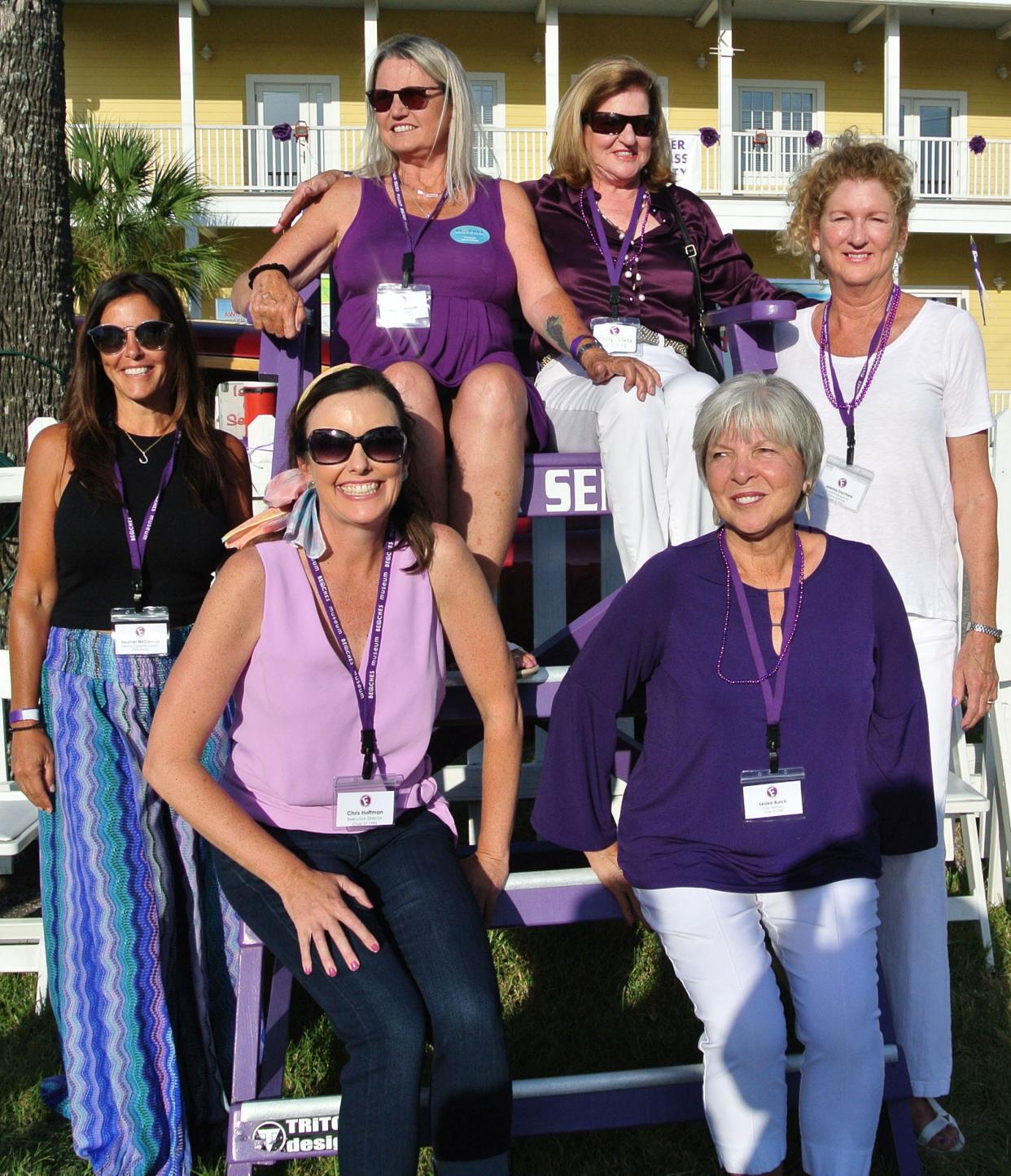 Members of the Fletcher All- Class Block Party committee climbed aboard the Fletcher Senators lifeguard chair for a photo. Included are Heather McConville, '95, (from left) co-chair Margie Horvatch, '74, (seated left),  Cathy Peper, '74, Joanna Stachura, '76, museum executive director and Jax Beach Mayor Chris Hoffman, '95 (seated front left) and Leslie Burch, '69.