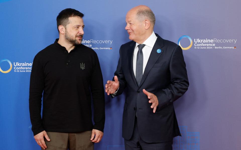 German Chancellor Olaf Scholz greets Ukrainian president Volodymyr Zelensky. T he conference will run over two days