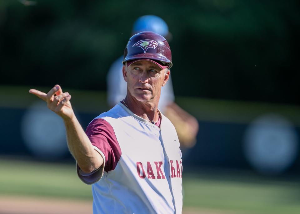 Oak Hall head coach Kevin Maris signals during an FHSAA baseball game at Oak Hill School in Gainesville, FL on Friday, April 19, 2024. [Alan Youngblood/Gainesville Sun]