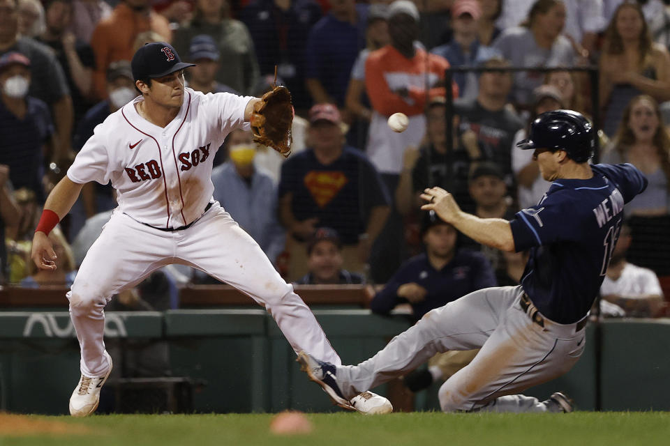 Boston Red Sox's Bobby Dalbec gets the throw at third base to tag out Tampa Bay Rays' Joey Wendle for the final out in the Red Sox's 2-1 win over Tampa Bay Rays in a baseball game Wednesday, Sept. 8, 2021, at Fenway Park in Boston. (AP Photo/Winslow Townson)