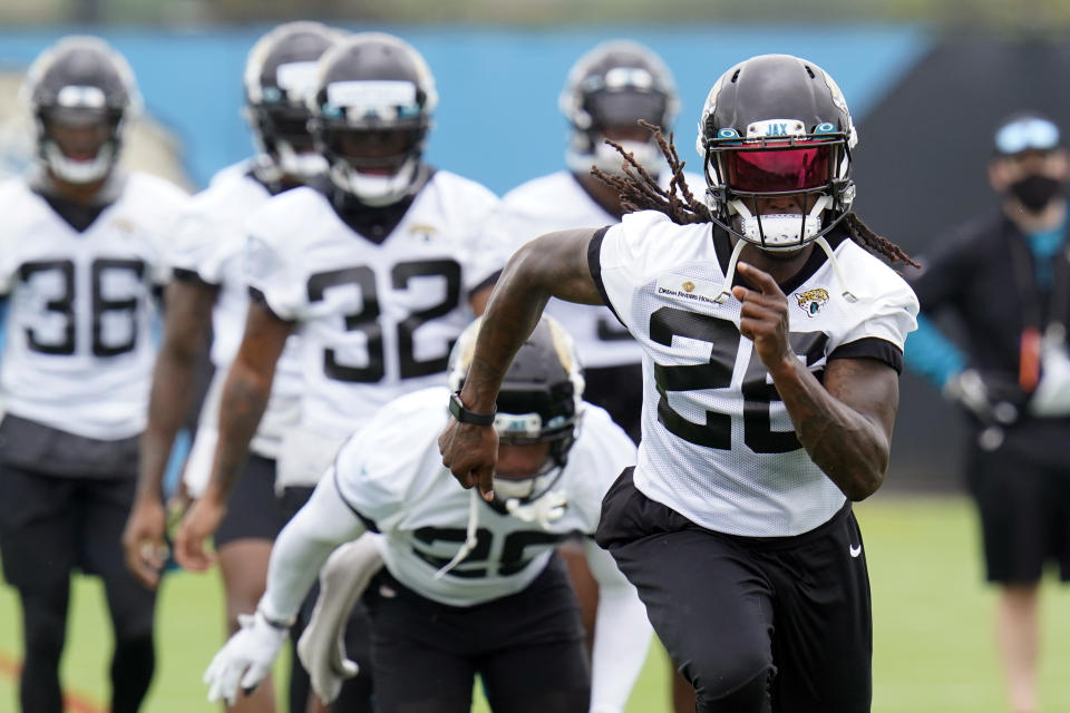 FILE - Jacksonville Jaguars cornerback Shaquill Griffin, front, runs sprints with teammates during an NFL football practice in Jacksonville, Fla., in this Monday, June 14, 2021, file photo The Griffin twins are already talking trash three months before they’re on opposite sidelines for the first time in their lives. Shaquill and Shaquem Griffin were teammates at every level of football growing up in St. Petersburg. They also played together at UCF and with the Seattle Seahawks the last three years. The seemingly inseparable brothers hit free agency in March and hoped to be reunited again. But it didn’t work out. (AP Photo/John Raoux, File)