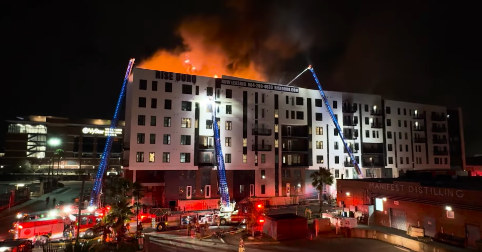 As the fire re-ignites, crews from seven ladder trucks battle the Jan. 28 blaze at the luxury apartments that were supposed to open March 1 in Jacksonville's sports and entertainment district.