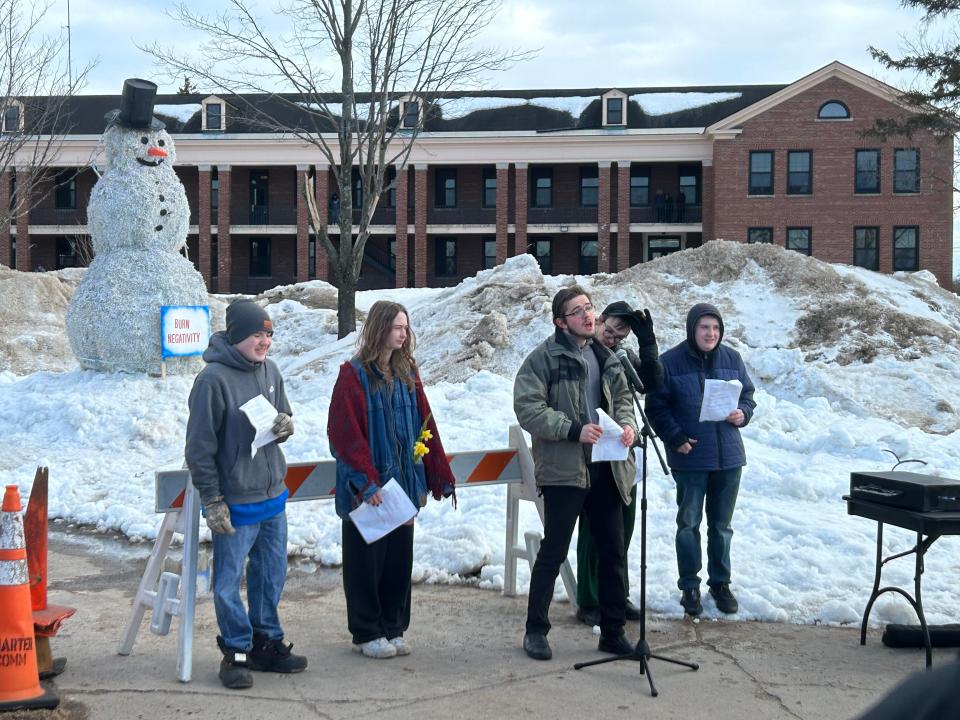 Students from a creative writing club at LSSU read community sourced poems about spring and rebirth at the annual snowman burning event on March 20, 2023.