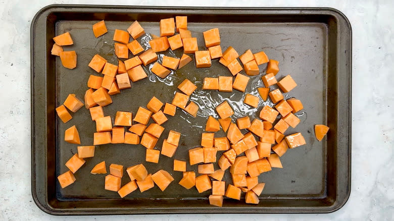 cubed sweet potatoes on sheet pan
