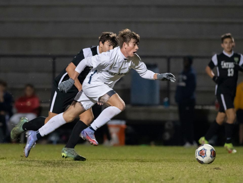 Will Woodward (9) drives the ball toward the Crusaders goal during the Gulf Breeze vs Catholic boys soccer game at Pensacola Catholic High School on Wednesday, Dec. 8, 2021.