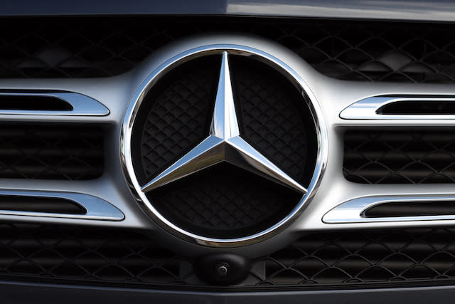 General view of a Mercedes car badge on the front grill of a car