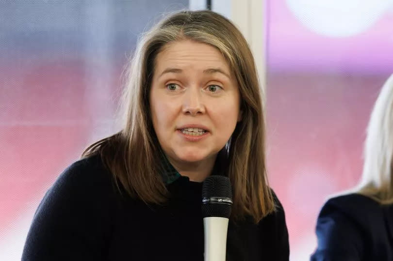 A woman speaking into a microphone