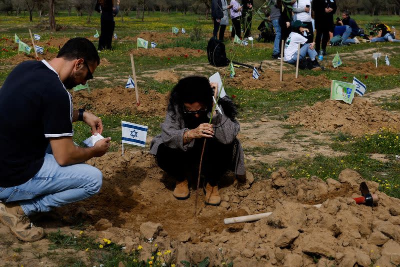 Family members and relatives visit the site of the Nova festival, in Reim