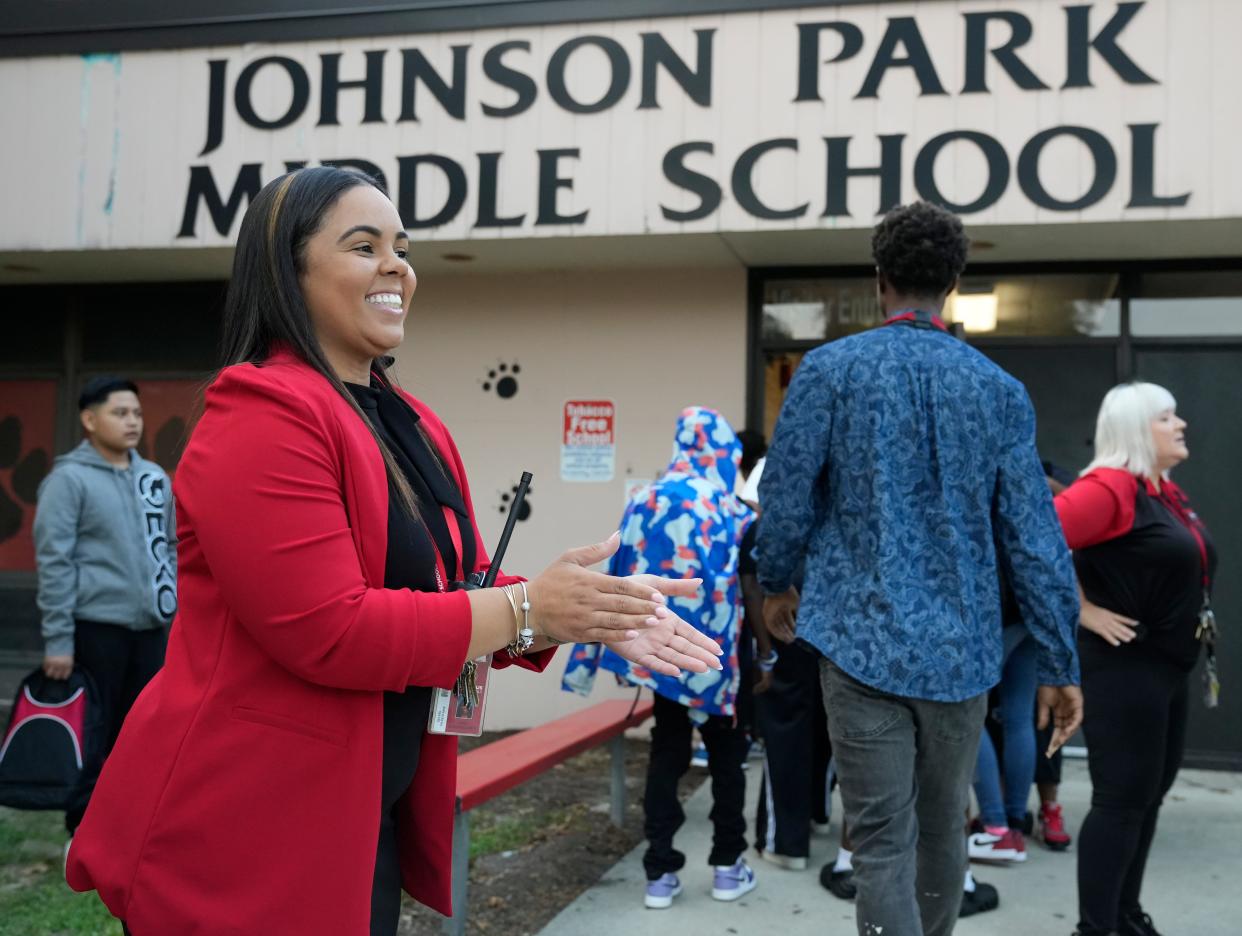 Janei Schundelmier, assistant principal at Johnson Park Middle School, welcomes students Aug. 23 on the first day of school for most Columbus City Schools students.