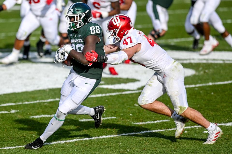 Michigan State's Trenton Gillison, left, catches a pass as Indiana's Micah McFadden closes in during the third quarter on Saturday, Nov. 14, 2020, at Spartan Stadium in East Lansing.