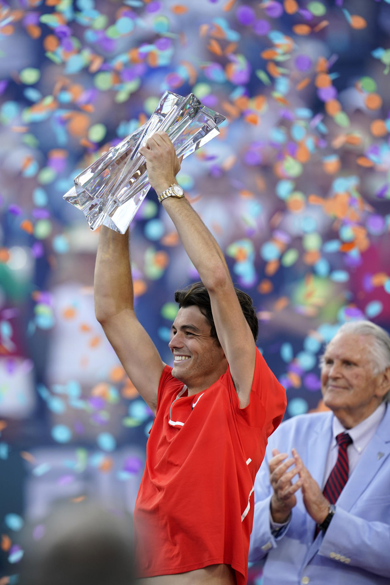 Taylor Fritz holds up his trophy after defeating Rafael Nadal, of Spain, during the men's singles finals at the BNP Paribas Open tennis tournament Sunday, March 20, 2022, in Indian Wells, Calif. Fritz won 6-3, 7-6. (AP Photo/Marcio Jose Sanchez)