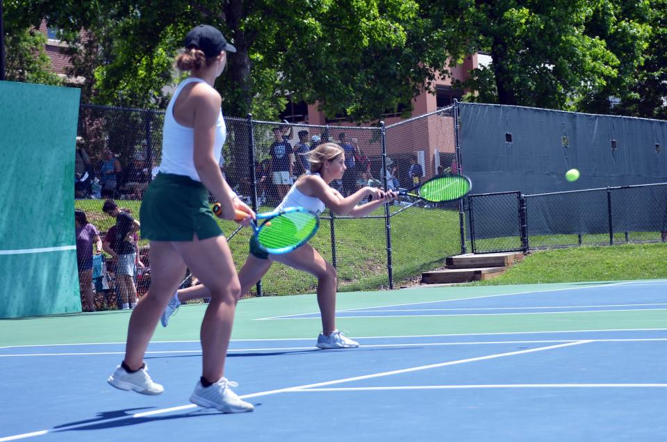South Hagerstown junior Amanda Frushour hits a backhand as senior Mackenzie Fritz watches during the Maryland Class 3A girls doubles semifinal on May 28 at the Wilde Lake Tennis Club.