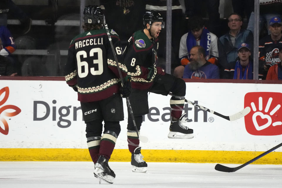 Arizona Coyotes center Nick Schmaltz (8) celebrates after his goal against the New York Islanders as Coyotes left wing Matias Maccelli (63) looks on during the second period of an NHL hockey game Thursday, Jan. 4, 2024, in Tempe, Ariz. (AP Photo/Ross D. Franklin)