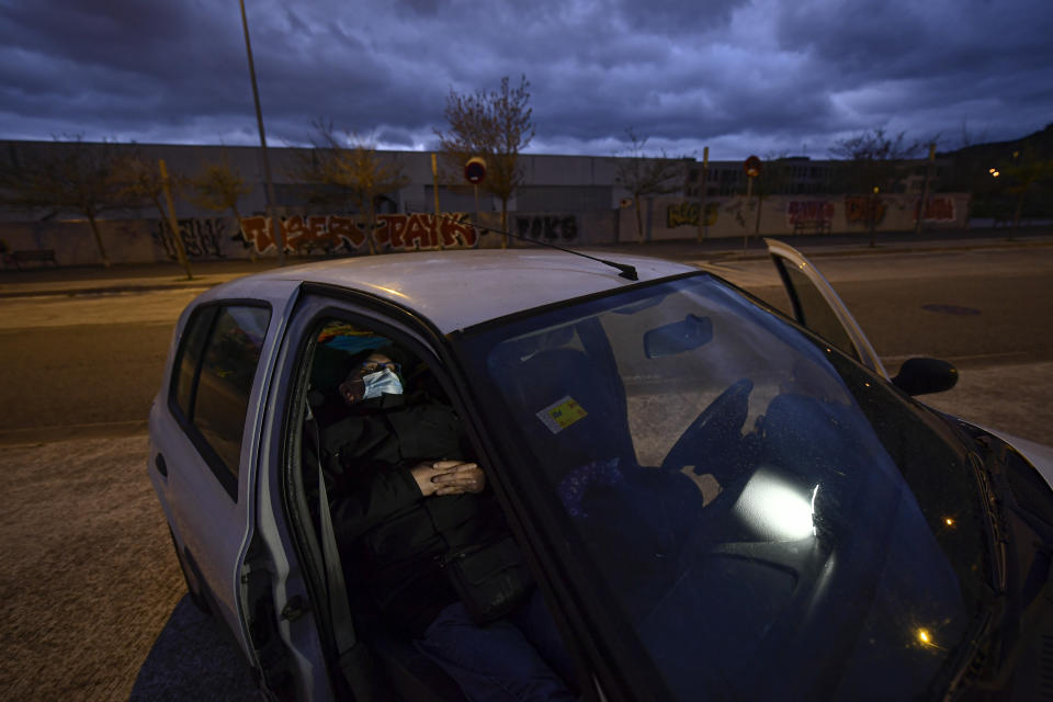 Javier Irure, 65 sits in his car which is now his home, in Pamplona, northern Spain, Thursday, March 18, 2021. Javier Irure had only one possible roof to put over his head when the 65-year-old Spaniard was evicted after the economic slowdown caused by the coronavirus pandemic destroyed his financial stability. Irure moves his car from one quiet parking spot to another on the outskirts of the northern Spanish city of Pamplona, where he once had a home. (AP Photo/Alvaro Barrientos)