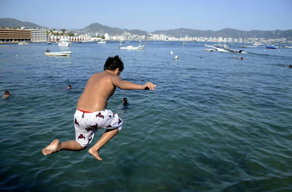 A youngster jumps into the Coyuca Lagoon, near Acapulco, Guerrero state, Mexico on March 14, 2020. - April 22, 2020 commemorates the 50th anniversary of the World Earth Day. (Photo by FRANCISCO ROBLES / AFP) (Photo by FRANCISCO ROBLES/AFP via Getty Images)