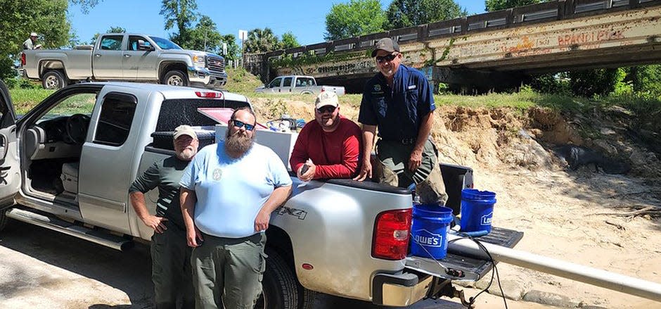 Freshwater fisheries researchers and managers with the Florida Fish and Wildlife Conservation Commission are pictured during the release of 3,300 shoal bass fingerlings May 10 into the Chipola River.