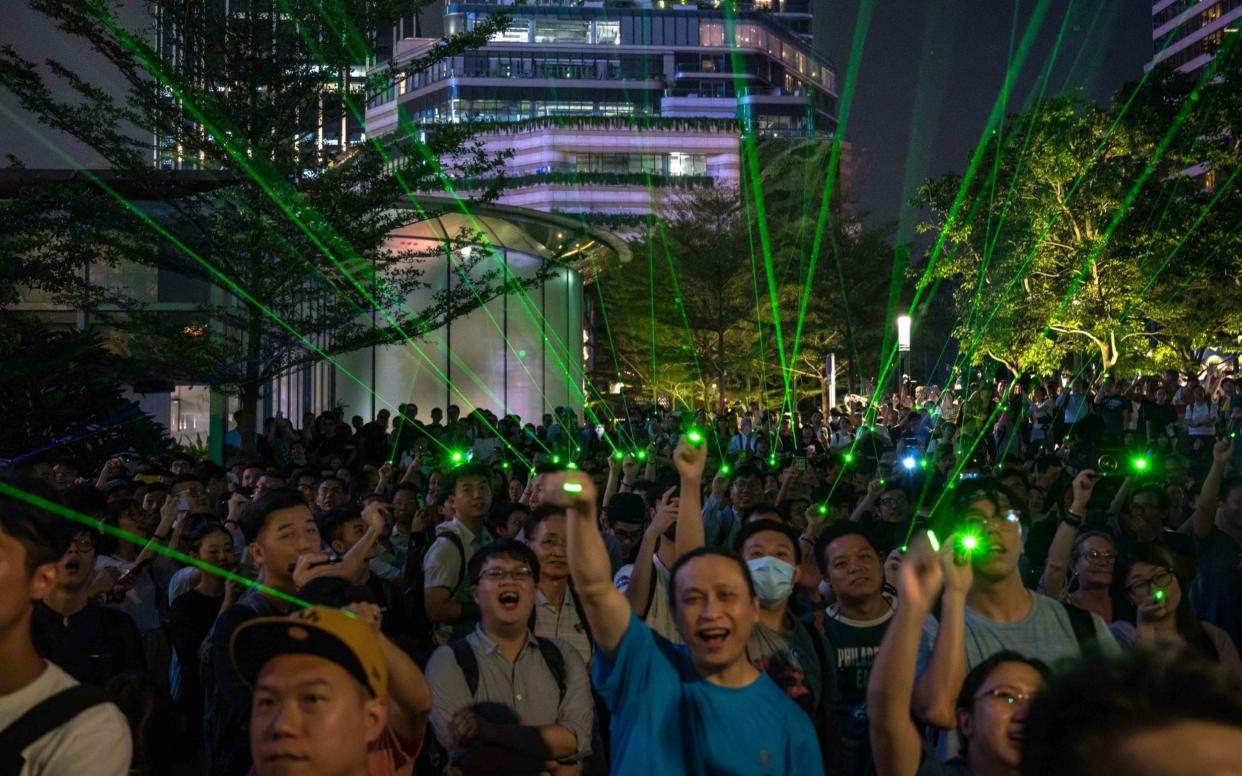 Protesters point laser beams at the Hong Kong Space Museum during a demonstration - Getty Images AsiaPac