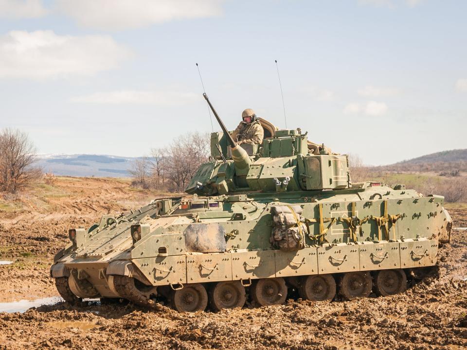 An M2 Bradley assigned to Company A, 1st Battalion, 18th Infantry Regiment, 2nd Armored Brigade Combat Team, 1st Infantry Division, Fort Riley, Kansas, traverses muddy terrain after successfully completing crew qualifications at the Novo Selo Training Area, Bulgaria, on March 20, 2018.