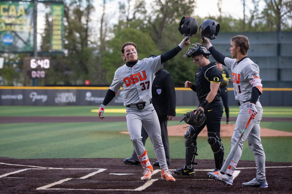 Oregon State's Travis Bazzana celebrates with teammate Gavin Turley after Bazzana hit a home run April 30 against Oregon in Eugene, Ore.