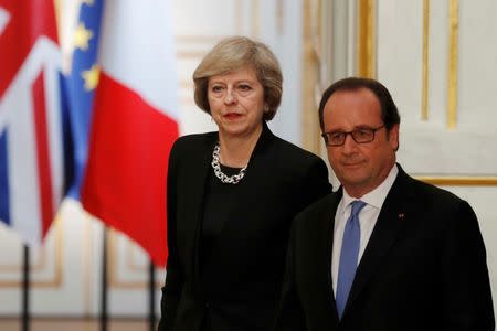 French President Francois Hollande (R) and Britain's Prime Minister Theresa May arrive to attend a news conference at the Elysee Palace in Paris, France, July 21, 2016. REUTERS/Philippe Wojazer