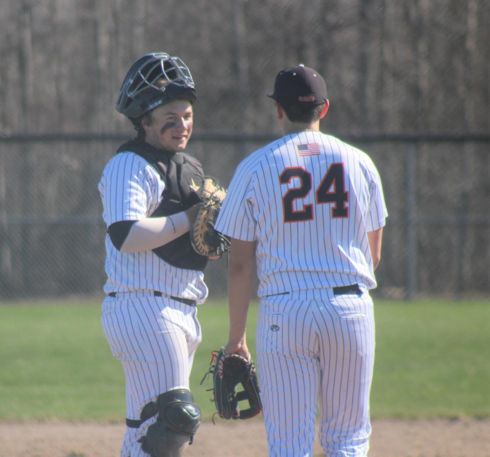 Cheboygan junior catcher Dylan Balazovic (left) and senior pitcher Jacob Jankoviak (24) chat on the mound during game one against Sault Ste. Marie.