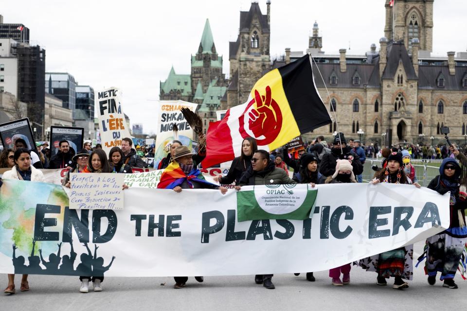 FILE - People participate in a March to End the Plastic Era on Parliament Hill in Ottawa, Ontario, on April 21, 2024. (Spencer Colby/The Canadian Press via AP, File)