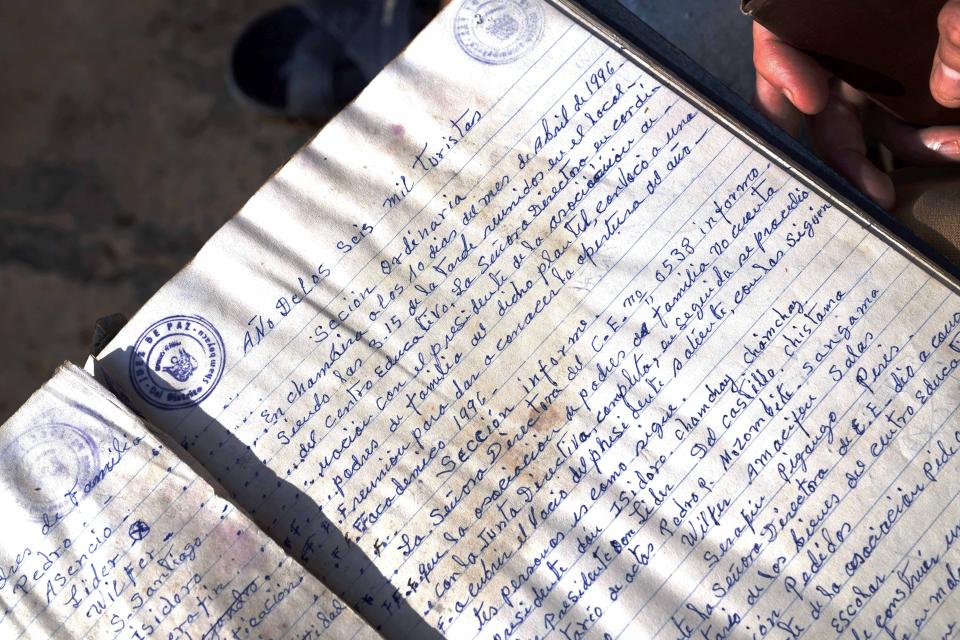 A book in which chiefs of communities document community meetings has the headline, "Year of the 6,000 tourists" in Chambira community, Peru, Wednesday, Oct. 5, 2022. (AP Photo/Martin Mejia)