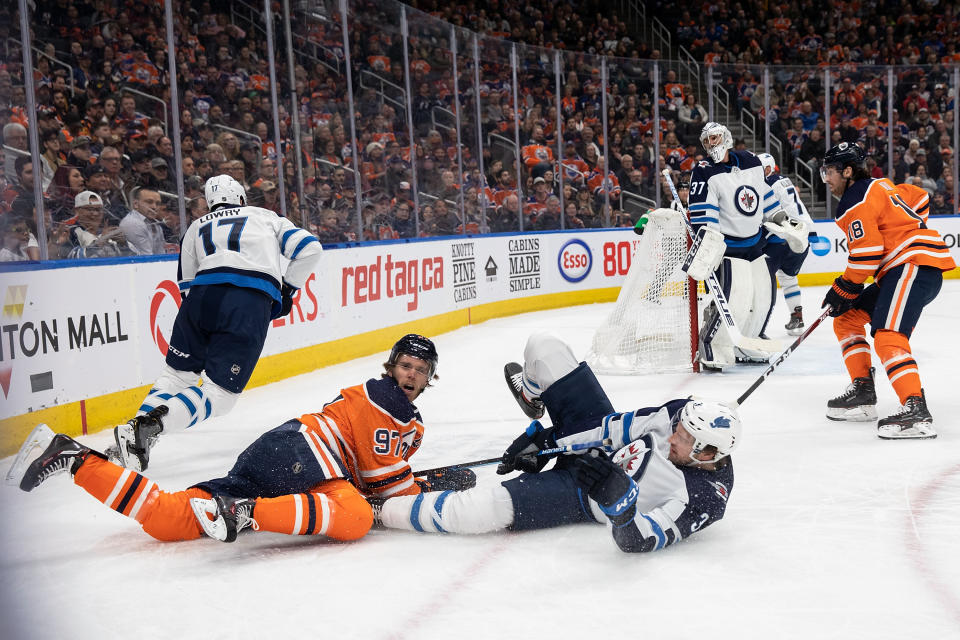 EDMONTON, AB - MARCH 11: Connor McDavid #97 of the Edmonton Oilers battles against Tucker Poolman #3 of the Winnipeg Jets at Rogers Place on March 11, 2020, in Edmonton, Canada. (Photo by Codie McLachlan/Getty Images)