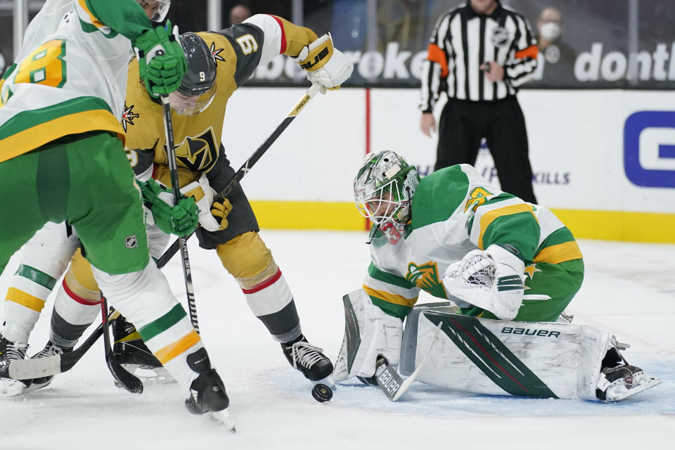 Minnesota Wild goaltender Cam Talbot (33) stops an attempted shot by Vegas Golden Knights center Cody Glass (9) during the second period of an NHL hockey game Wednesday, March 3, 2021, in Las Vegas. (AP Photo/John Locher)