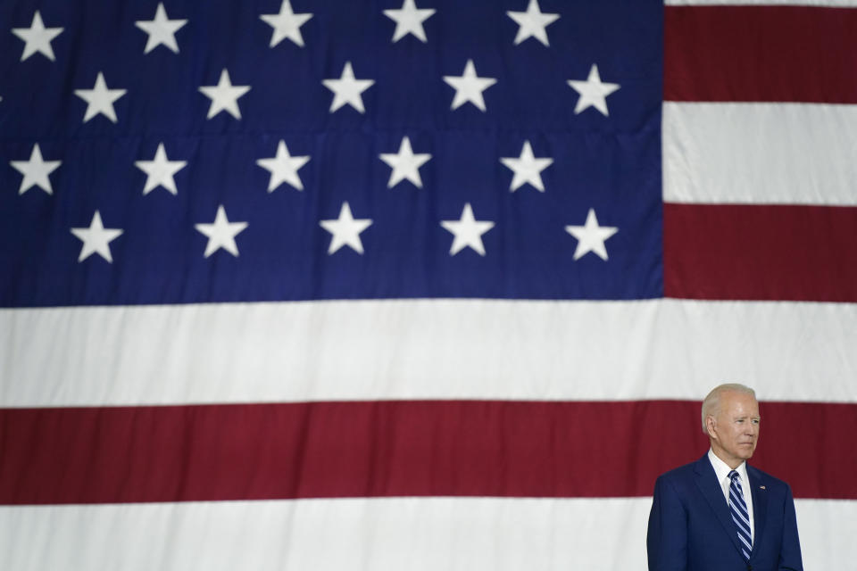 President Joe Biden listens first lady Jill Biden speaks at Joint Base Langley-Eustis in Hampton, Va., Friday, May 28, 2021. (AP Photo/Patrick Semansky)