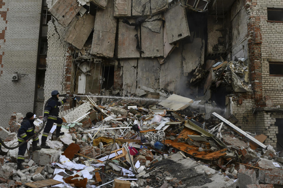 Firefighters work at the scene of a damaged residential building after Russian shelling in the liberated Lyman, Donetsk region, Ukraine, Monday, Nov. 7, 2022. (AP Photo/Andriy Andriyenko)