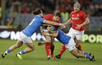 Wales' Jake Ball, center, is tackled by Italy's Michele Campagnaro, left, and Italy's Guglielmo Palazzani during the Six Nations rugby union international between Italy and Wales, at Rome's Olympic Stadium, Saturday, Feb. 9, 2019. (AP Photo/Andrew Medichini)