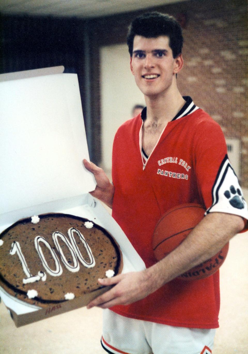 Rob Keller, who graduated from Central York High School in 1986, holds a cake he received for scoring his 1,000th career point. He still holds the Panthers' boys' basketball scoring record with 1,252 points.