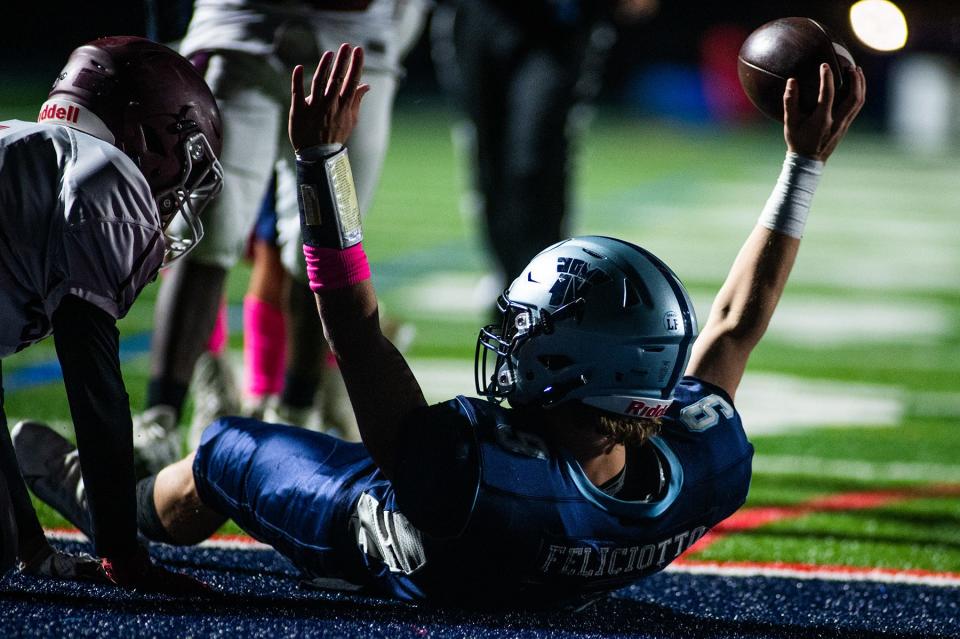 John Jay-East Fishkill's Brady Feliciotto celebrates a touchdown on the ground during the Section 1 football game at John Jay-East Fishkill in Wiccopee on Friday, October 21, 2022.