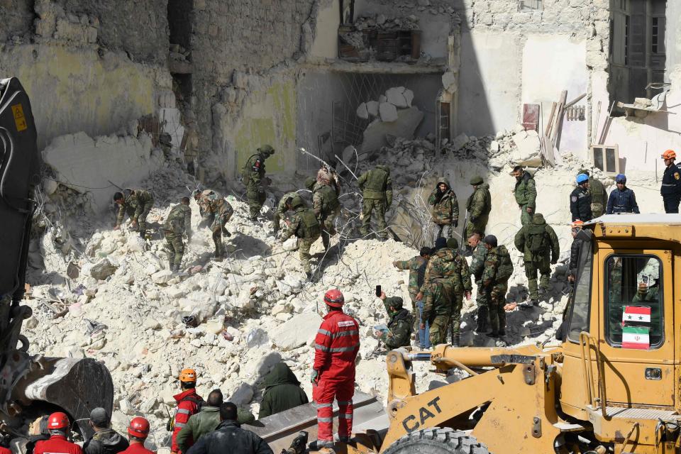 Iranian rescuers and Syrian soldiers sift through the rubble of a collapsed building in the northern city of Aleppo, searching for victims and survivors days after a deadly earthquake hit Turkey and Syria on Feb. 9, 2023.