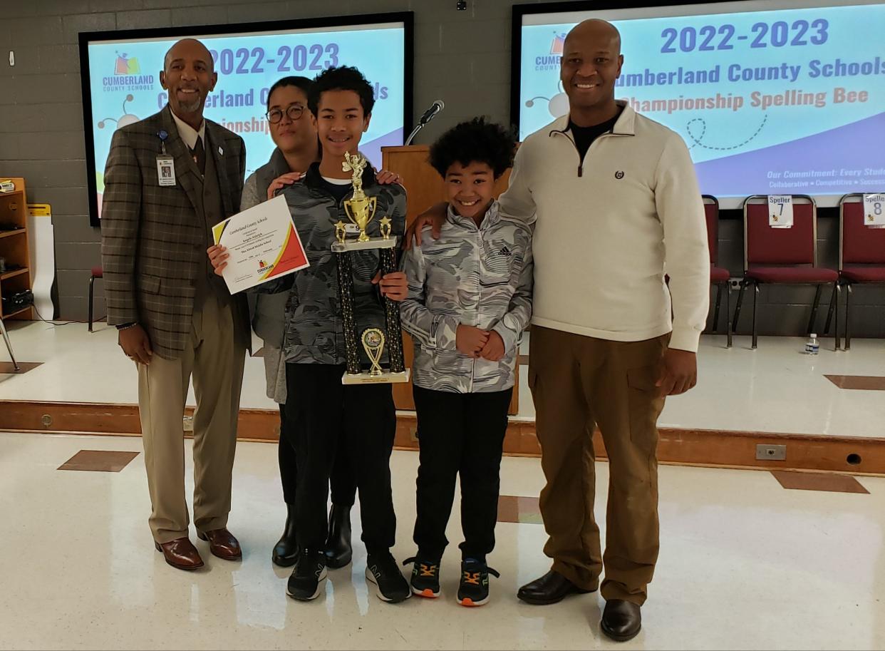 Angelo Aldoph, 13, center, won the Level III Cumberland County spelling bee on Friday, Feb. 10, 2023. He is shown with Dr. Marvin Connelly, left, Cumberland County Schools superintendent and Angelo's family, parents Sachiko and Jean Aldoph and brother, Danielo.