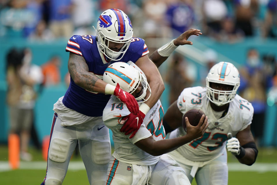 Miami Dolphins quarterback Jacoby Brissett (14) is sacked by Buffalo Bills defensive end A.J. Epenesa (57) during the second half of an NFL football game, Sunday, Sept. 19, 2021, in Miami Gardens, Fla. (AP Photo/Wilfredo Lee)