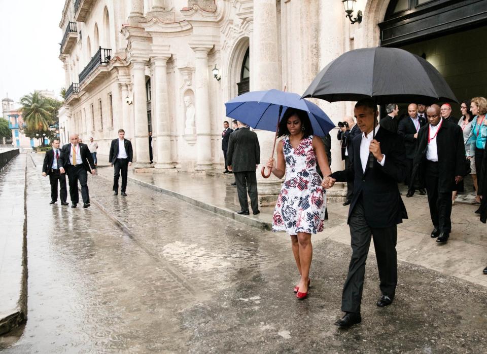 Obama and first lady Michelle Obama walk to the motorcade after touring Old Havana, Cuba.