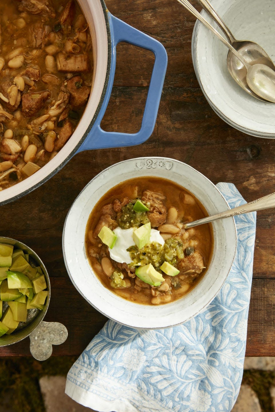 white turkey and poblano chili in a bowl and in a dutch oven next to it