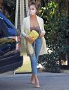 <p>Chrissy Teigen wears a coordinating sweater and purse while out to lunch with her family in L.A. on Monday. </p>