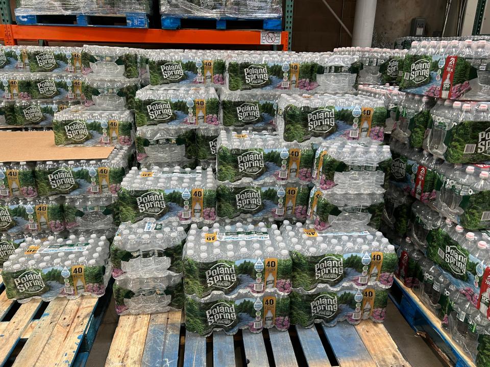 poland springs water bottles on wood palette at costco